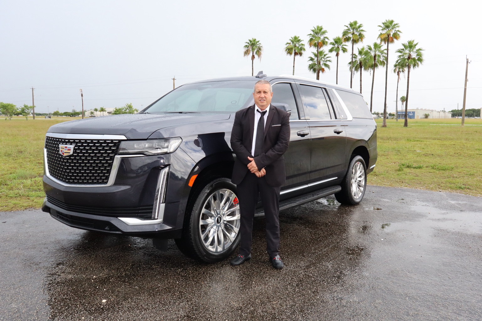Professional chauffeur with Cadillac Escalade